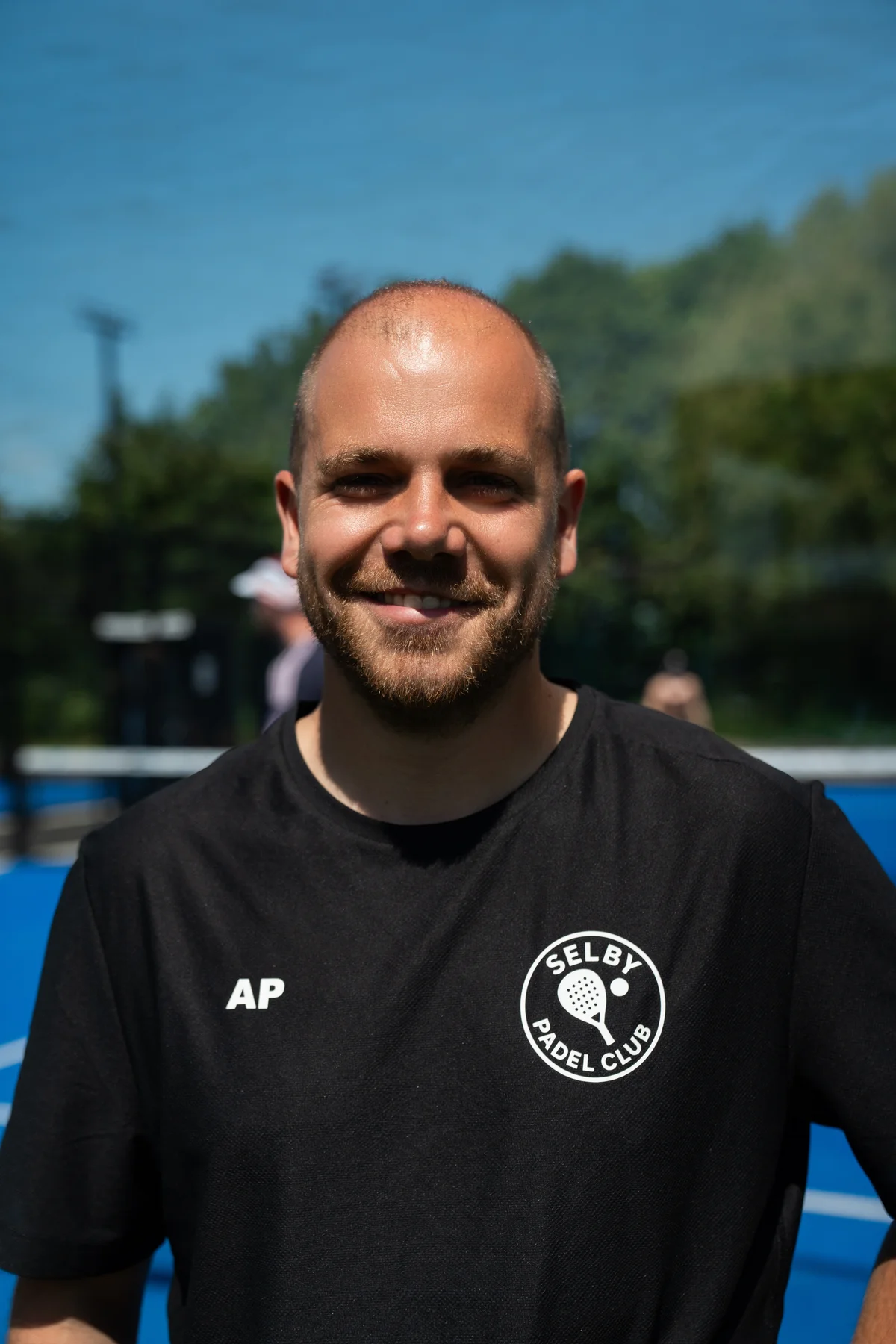 Adam Purnell, Adult Coach at Selby Padel Club, standing on court