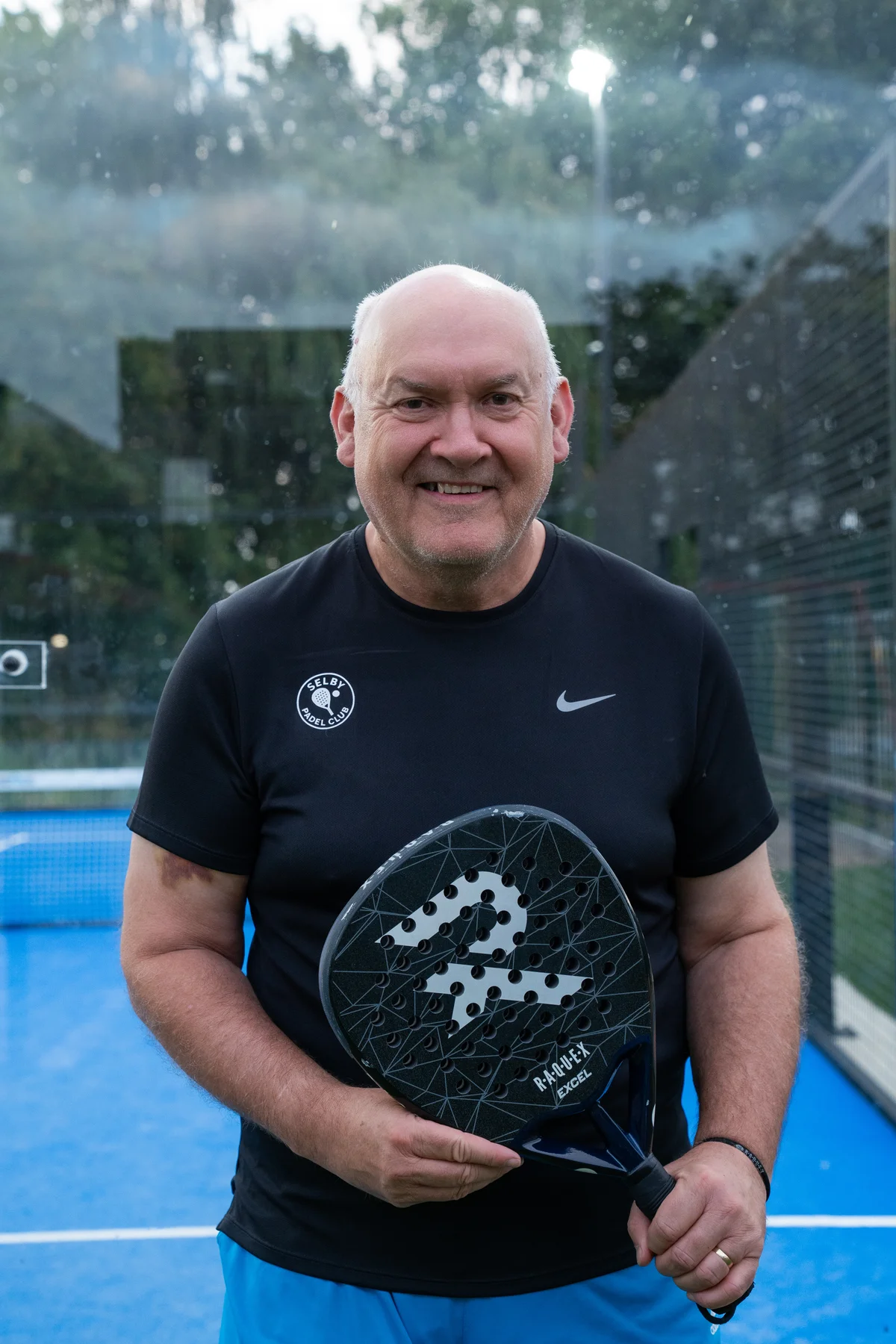 Dave Pegg, Junior Coach at Selby Padel Club, holding a padel racket on court